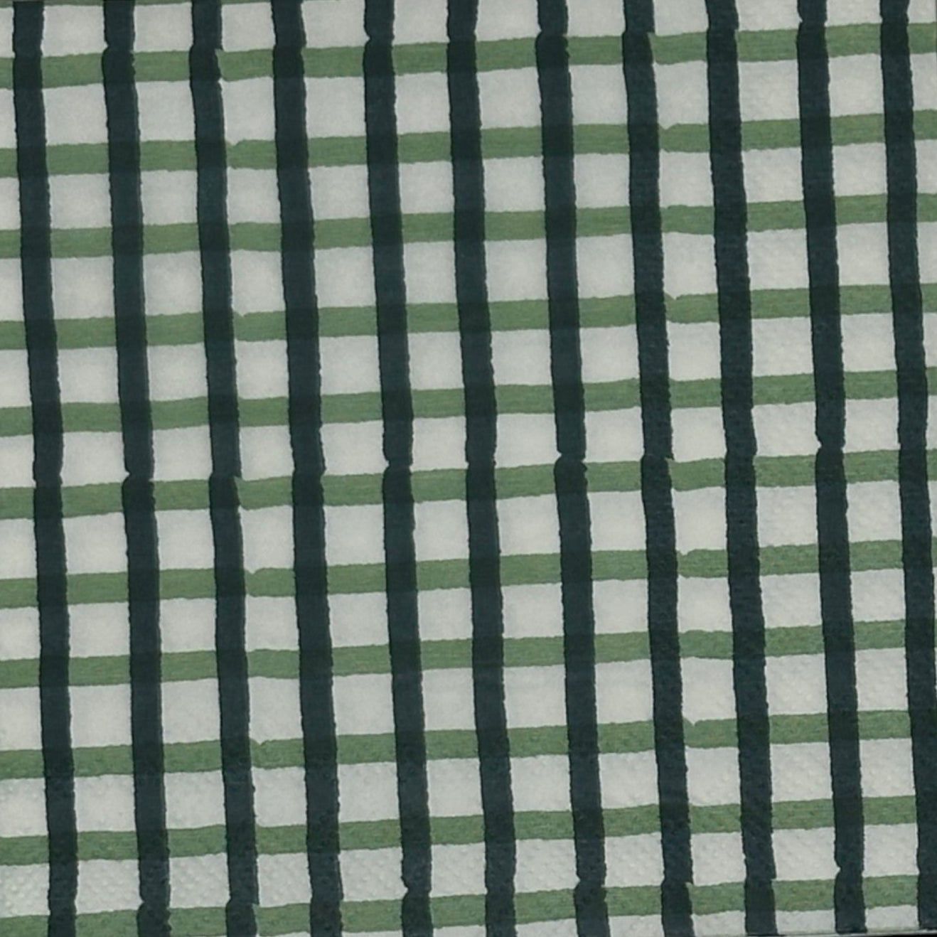 white paper napkin with a dark green check pattern