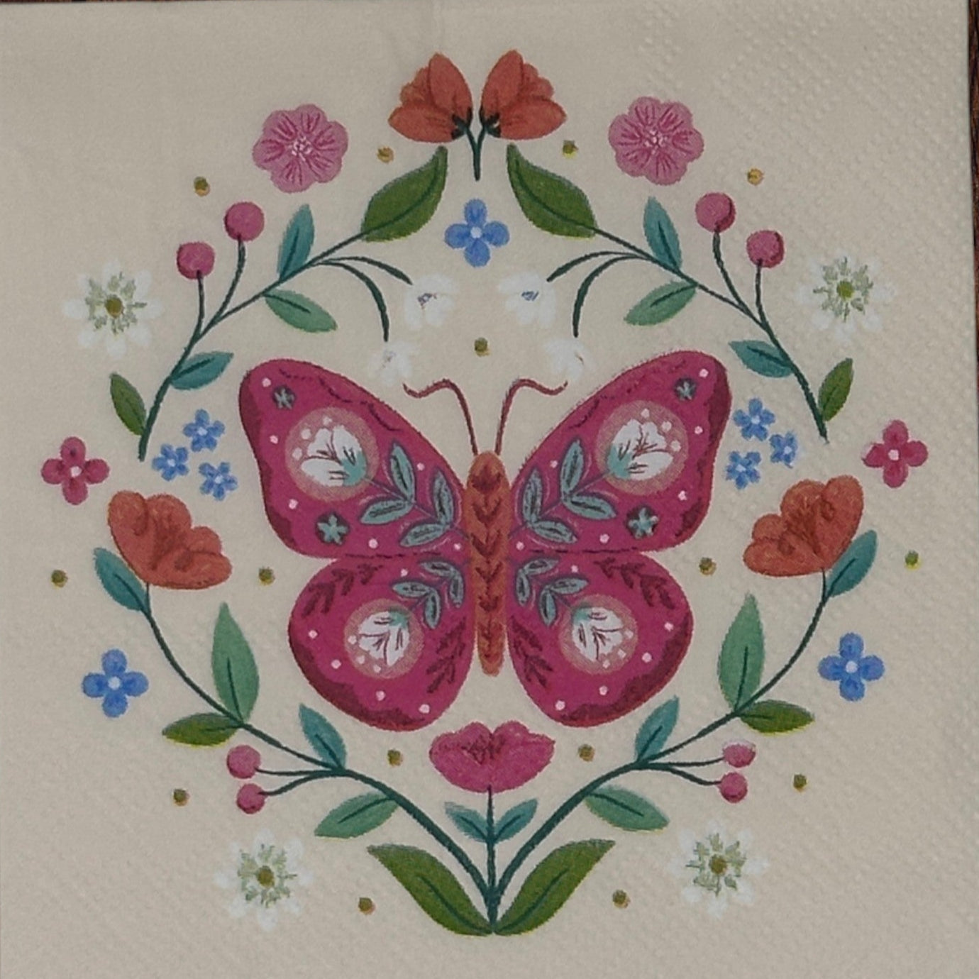 pink paper napkin with a fuschia butterfly and floral designs