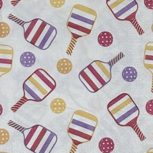 white paper napkin with colorfull pickleball rackets and balls