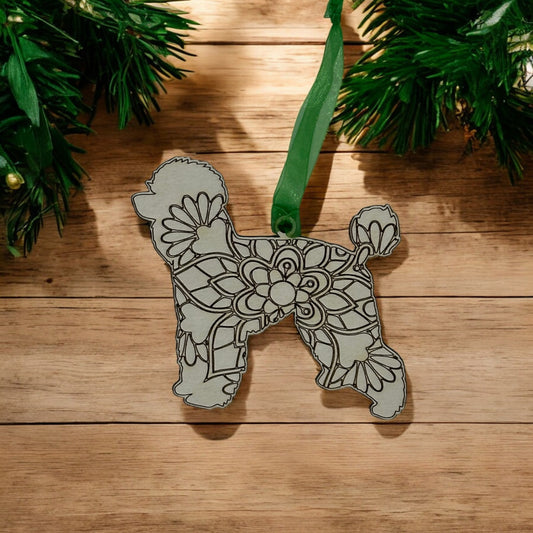 wooden poodle doodle ornament that has a mandala design carved and hangs from a green ribbon