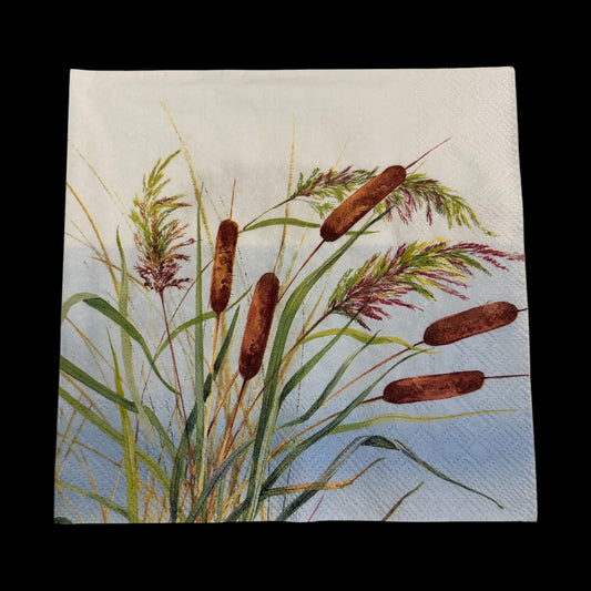 Luncheon size decoupage napkin featuring watercolor reeds and cattails in shades of green, brown, and purple on a blue sky background for nature crafts.
