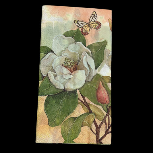 Guest size decoupage napkin featuring white magnolia flowers, green leaves, and a butterfly on a soft background, ideal for floral crafts and spring decor.