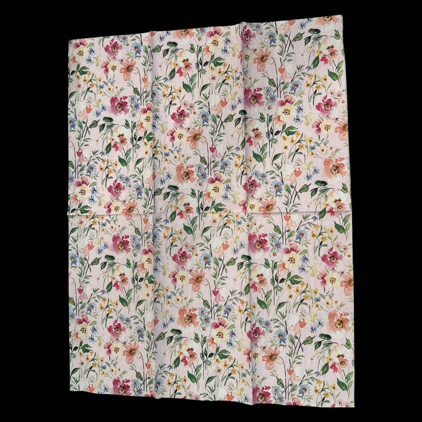 Unfolded Guest size decoupage napkin featuring watercolor flowers in pink, rose, blue, and yellow on a soft blush background—perfect for spring floral crafts.