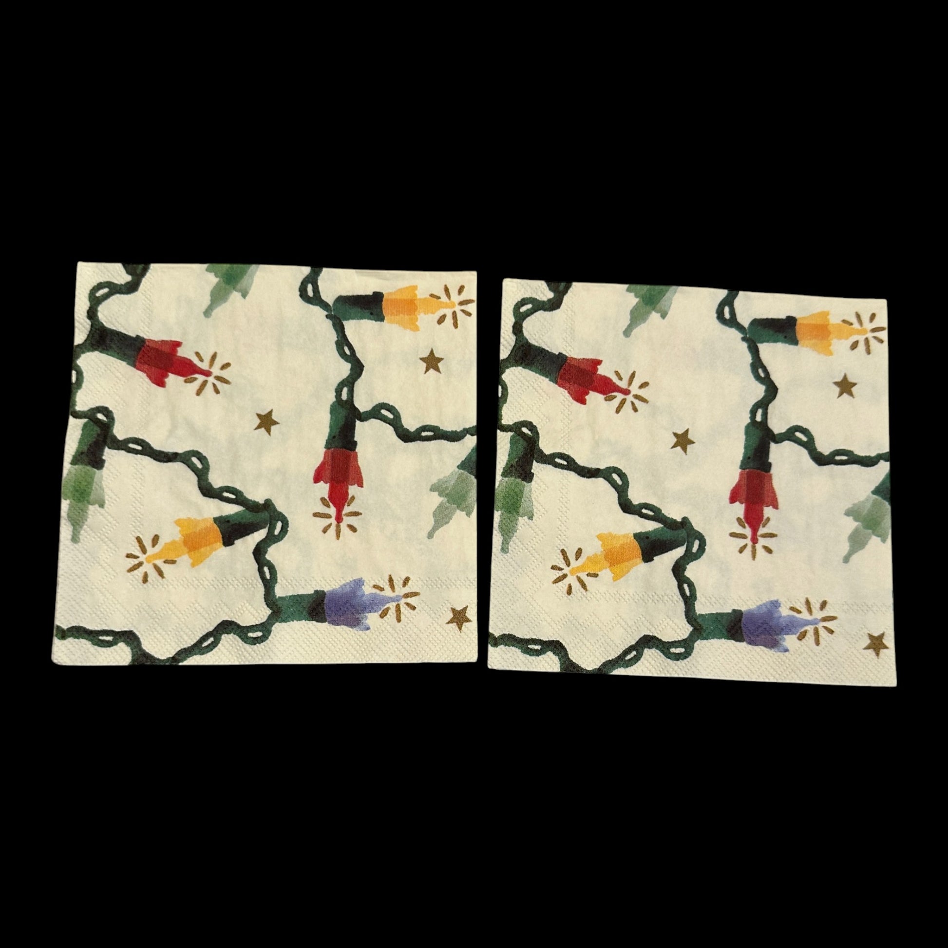 Two Christmas string light decoupage napkin featuring colorful red, yellow, green, and blue bulbs with glowing accents and small gold stars on a cream background.