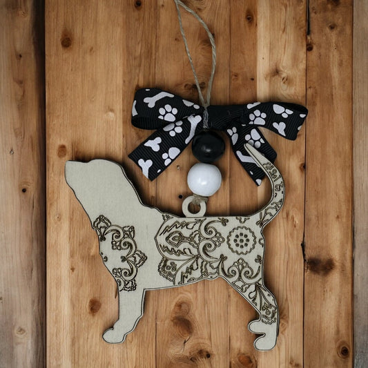 wooden bloodhound memorial ornament carved mandala design hanging on a jute string and features a black ribbon with white paw prints